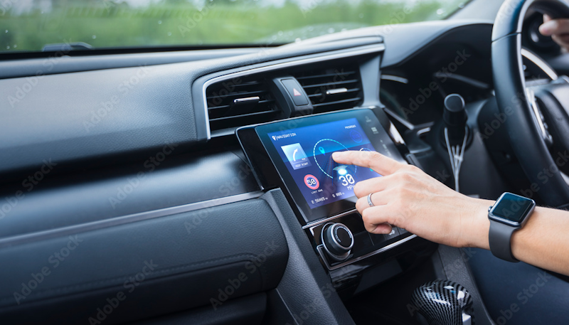 Modern car dashboard with futuristic AI interface displaying predictive navigation routes and intelligent climate control settings while driver enjoys hands-free voice-activated smart car technology in 2026 - InfoProds 2026