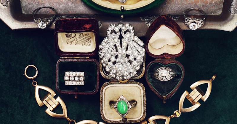 Authentic Art Deco vintage jewelry collection displaying geometric designs, rhinestone brooches, and signed designer pieces from 1920s-1930s with visible maker's marks and hallmarks under magnification - collectible costume jewelry identification InfoProds 2026