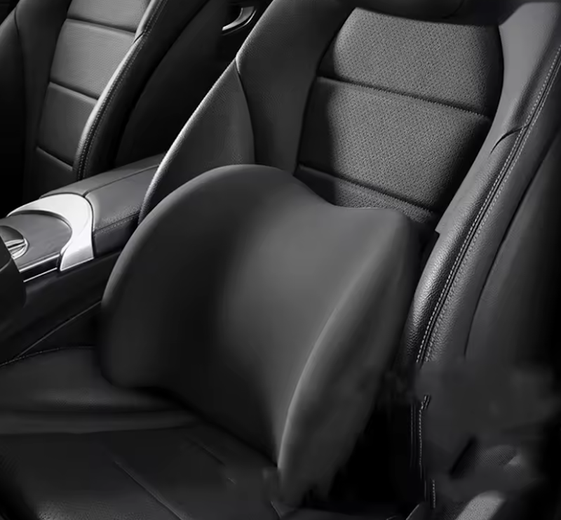 Ergonomic memory foam lumbar support cushion with breathable mesh cover installed on car seat providing lower back support for driver comfort