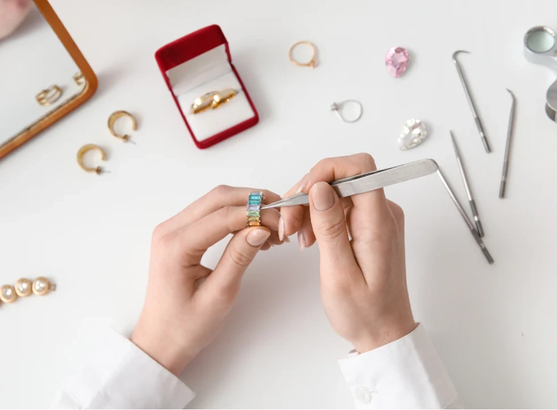 Professional Jewelry Maintenance - Annual Inspection and Repair Services for Fine Jewelry Professional jeweler examining diamond ring settings with loupe showing importance of regular jewelry inspection