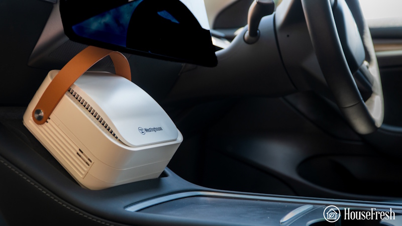 Professional laboratory scientist conducting scientific particle filtration testing on car air purifier HEPA filter measuring PM2.5 removal efficiency and clean air delivery rate performance - InfoProds 2026