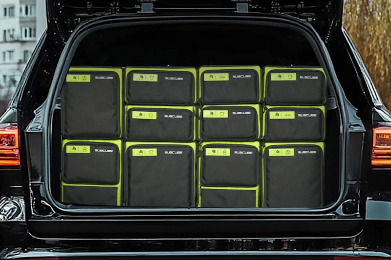 Organized EV Trunk Storage System with Modular Compartments for Road Trip Well organized electric vehicle cargo area featuring modular trunk storage system with labeled compartments for charging equipment clothing emergency supplies and travel accessories demonstrating efficient space utilization for extended EV road trip organization InfoProds 2026