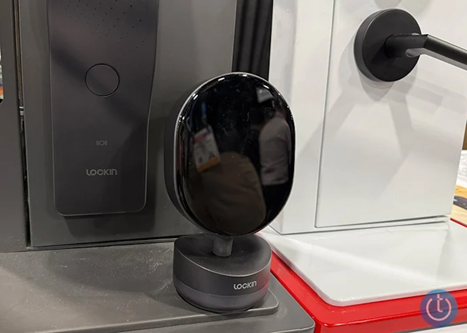 Optical Charging Smart Lock System with Infrared Wireless Power Transmitter Modern optical charging smart lock installation showing wireless power transmitter unit mounted on interior wall beaming infrared light energy to photovoltaic receiver panel integrated into door lock exterior housing, demonstrating battery-free home security technology for maintenance-free keyless entry systems in contemporary residential settings - InfoProds 2026