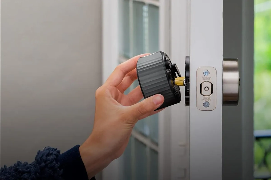 DIY Smart Lock Installation Deadbolt Replacement Home Improvement Homeowner installing optical charging smart lock replacing traditional deadbolt using basic Phillips screwdriver demonstrating simple DIY installation process requiring no permanent home modifications ideal for renters and apartment dwellers seeking reversible smart home security upgrades - InfoProds 2026