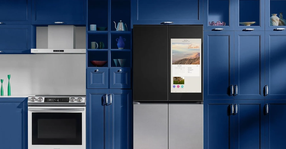 Modern stainless steel Samsung smart refrigerator with large interactive touchscreen mounted on door panel displaying digital food inventory management system with AI-powered recognition technology in contemporary kitchen setting with white countertops and natural lighting - InfoProds 2026 kitchen appliance technology comparison
