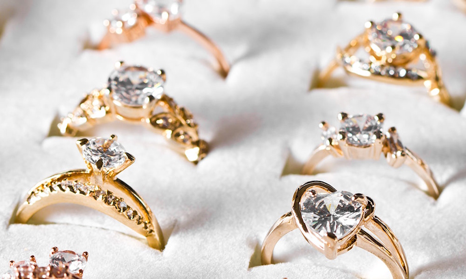 Variety of Ring Styles Showing Different Design Complexities Affecting Sizing. Collection of diverse ring designs including eternity bands, pavé settings, channel settings, and mixed metals, demonstrating how ring complexity affects resizing possibilities and sizing success rates in fine jewelry - InfoProds 2026