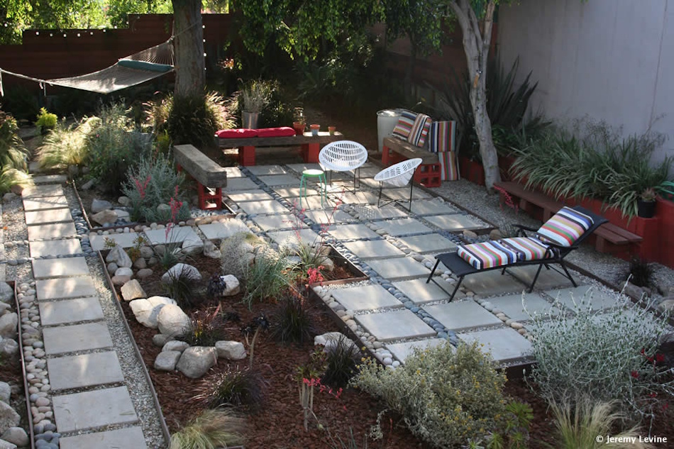 Lush healthy vegetable garden and ornamental landscape plants flourishing with sustainable greywater irrigation system showing water conservation benefits, reduced utility costs, and environmentally responsible home gardening practices in 2026 - InfoProds