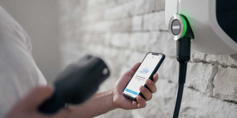 Smart EV Charger WiFi Connectivity Smartphone App Control Smart EV charger with WiFi connectivity displaying smartphone app interface for scheduling, monitoring, and controlling residential charging sessions and energy usage - InfoProds 2026