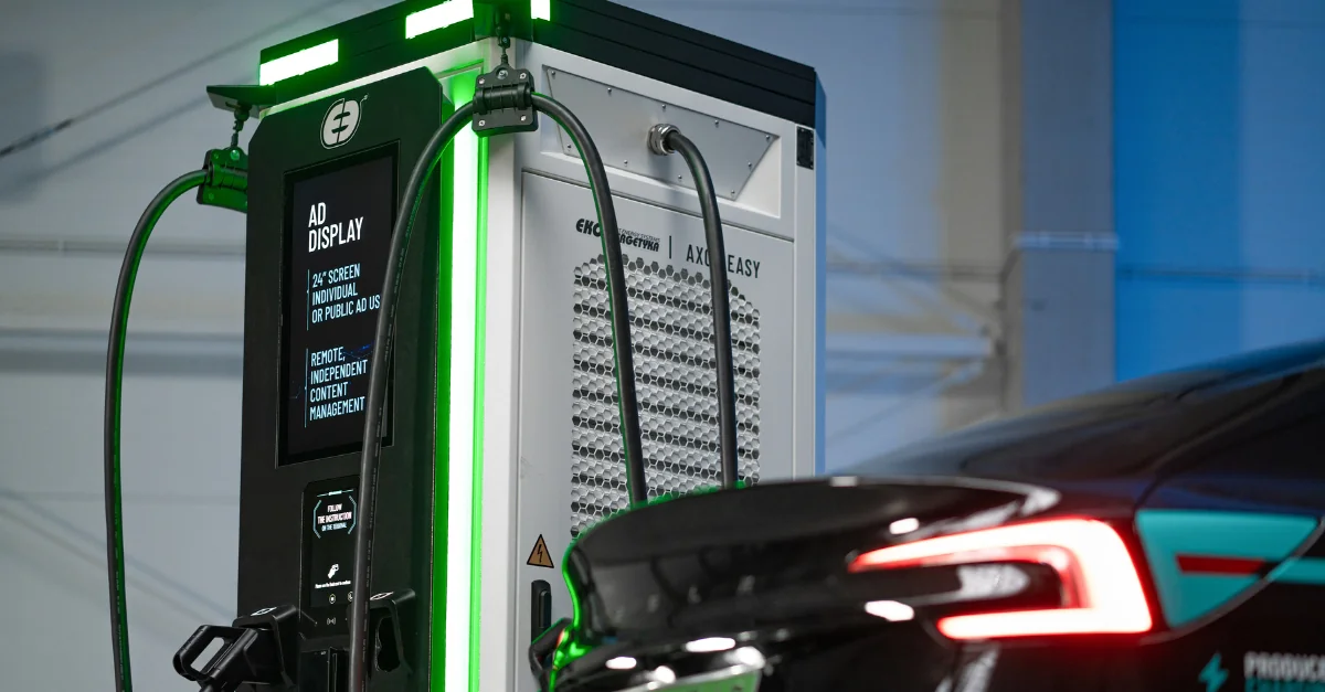 Public electric vehicle DC fast charging station with pricing display screen DC fast charging station displaying per-kilowatt-hour pricing and time-based fees showing public charging network costs for electric vehicles - InfoProds 2026