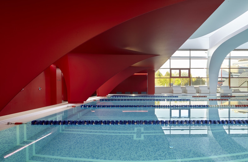 Futuristic Next-Generation Olympic Swimming Facility Concept Design Advanced conceptual design for future Olympic swimming venue incorporating cutting-edge wave elimination technology modular construction methods and artificial intelligence water quality management systems - InfoProds 2026