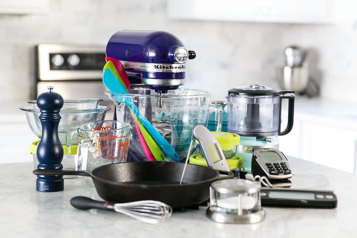 Complete collection of budget-friendly kitchen gadgets and essential cooking tools from restaurant supply sources arranged on modern kitchen counter, demonstrating that affordable equipment can deliver professional-quality cooking results - InfoProds Kitchen Essentials Guide 2026