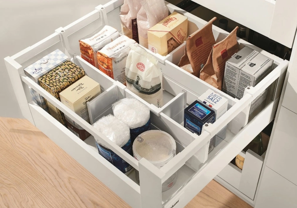 Well-organized kitchen drawer with adjustable dividers compartments showing properly stored tools containers and supplies preventing money waste through systematic organization - InfoProds 2026 organization systems
