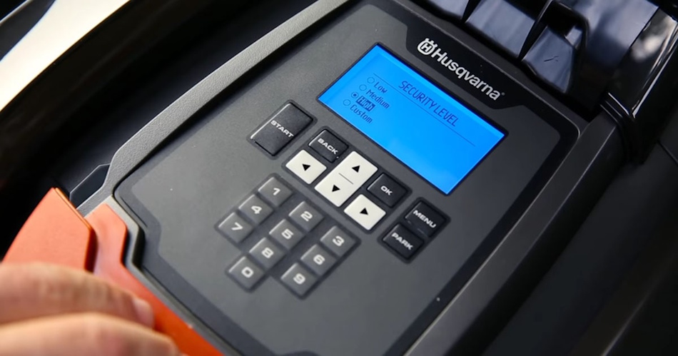 Robotic Mower Safety Features and Anti-Theft Security System Components Close-up view of robotic lawn mower showing enclosed blade safety mechanism, lift sensors, PIN code security pad, GPS tracking module, automatic blade stop system, consumer safety compliance labels - InfoProds Mower Safety Standards 2026