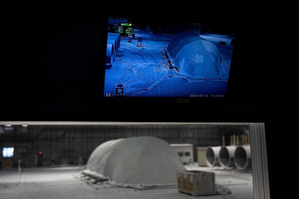 Emergency Shelter Deployment Training in Darkness and Rain Nighttime emergency scenario testing showing volunteer setting up survival shelter using headlamp illumination during simulated rainstorm conditions demonstrating real-world deployment challenges and time constraints - InfoProds Survival Skills Training 2026