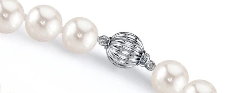 Box Clasp with Safety Latch on Pearl Strand Necklace Elegant box clasp with figure-eight safety latch on white pearl strand necklace demonstrating interlocking mechanism and redundant security features used in valuable fine jewelry pieces - InfoProds 2026
