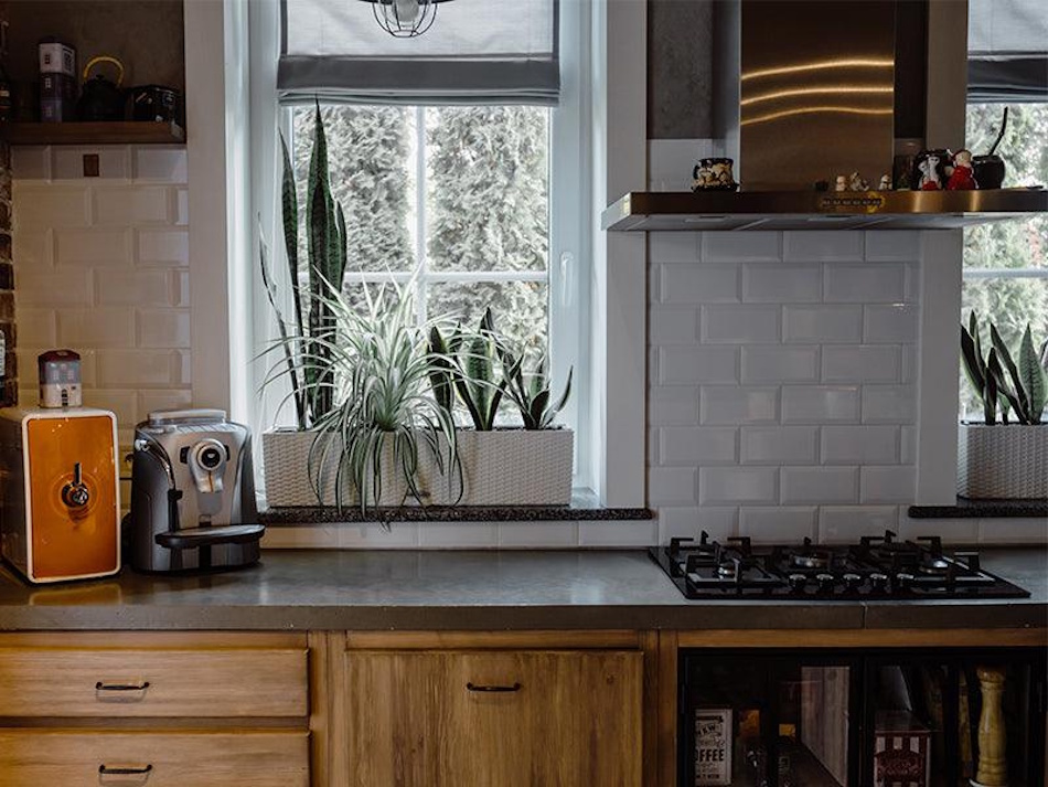 Modern Kitchen with Poor Ventilation and Invisible Toxic Air Contemporary residential kitchen with gas stove and no visible range hood exhaust system showing the hidden indoor air quality crisis from cooking emissions that causes respiratory illness in families across America - Kitchen Ventilation Failure Health Risks InfoProds 2026