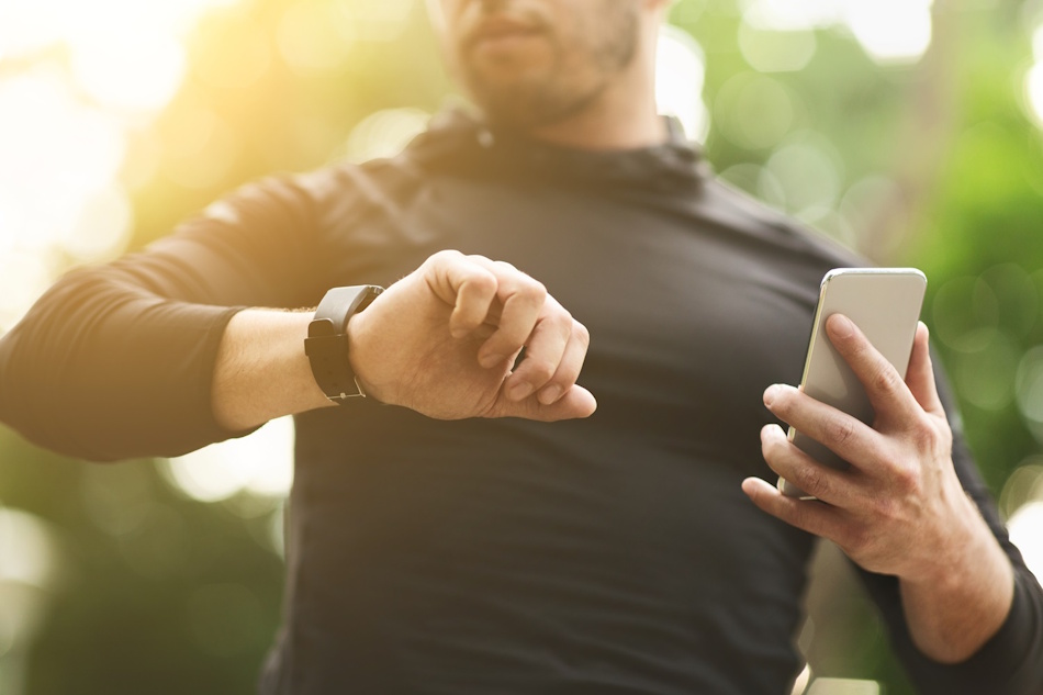 Person comparing walking and running workout data on fitness tracker device in 2026 Fitness enthusiast analyzing walking versus running statistics on smartwatch display showing calories burned, distance traveled, and heart rate metrics for evidence-based weight loss comparison - InfoProds 2026