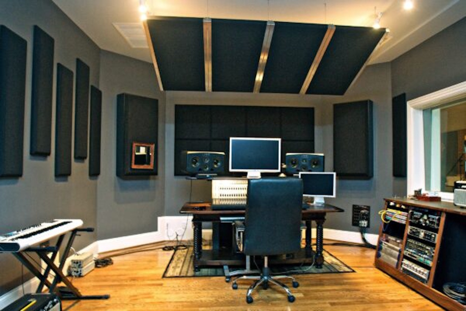 Home Recording Studio with Professional Acoustic Treatment Panels Professional home recording studio interior featuring comprehensive acoustic treatment including bass traps, absorption panels, and diffusers demonstrating military-grade soundproofing principles applied to residential space, showing multi-layer approach combining sound blocking barriers with strategic absorption for complete noise isolation - InfoProds 2026