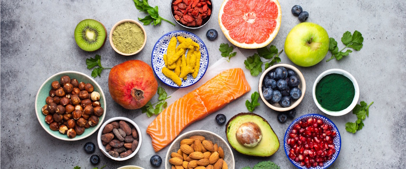 Recovery-supporting foods including tart cherries, fatty fish, sweet potatoes, berries, leafy greens, and turmeric showing anti-inflammatory nutrition accelerating muscle recovery and growth - InfoProds 2026