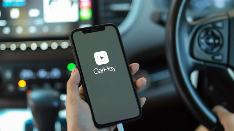 Smartphone Wireless Connection to Car Infotainment System iPhone and Android smartphone wirelessly connecting to modern car infotainment system demonstrating Bluetooth WiFi Direct pairing process for CarPlay and Android Auto integration technology - InfoProds 2026