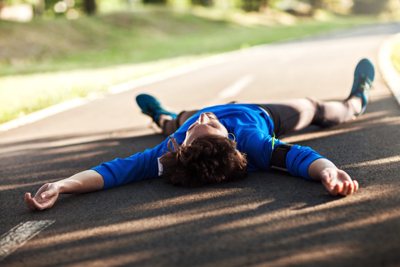 Exhausted marathon runner struggling with severe fatigue at mile 20 demonstrating glycogen depletion and metabolic crisis causing the wall phenomenon in distance running - InfoProds 2026