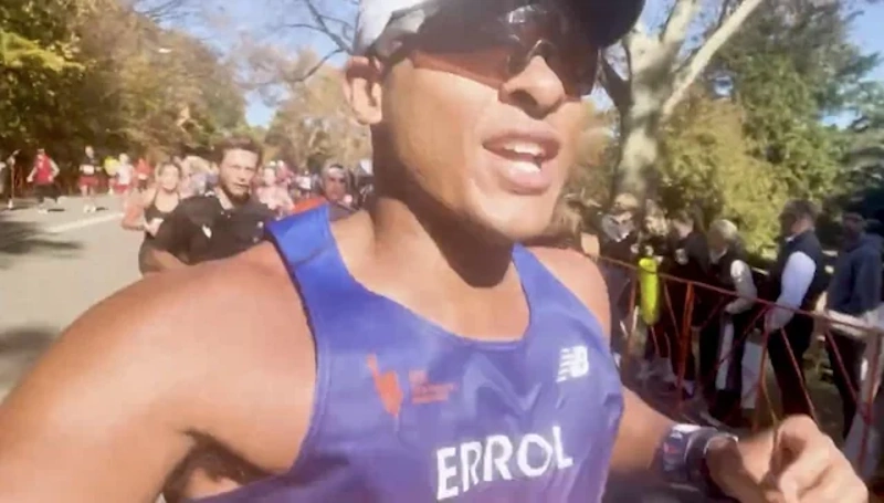 Marathon runner finishing strong with energy at mile 26 after implementing proper glycogen management, carbohydrate loading, and race fueling preventing the wall - InfoProds 2026.