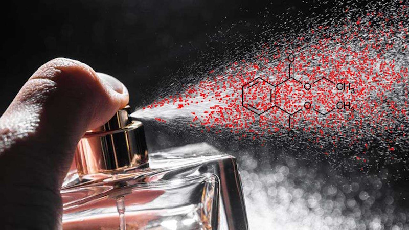 Perfume bottles and fragranced beauty products with molecular structure overlay showing hidden phthalates concealed behind generic fragrance ingredient listings without disclosure requirements - InfoProds 2026