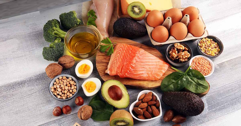 Variety of high quality whole food protein sources including grilled chicken breast lean beef salmon eggs Greek yogurt arranged on wooden table demonstrating complete nutrition micronutrients and cost effective muscle building meal planning strategies InfoProds 2026